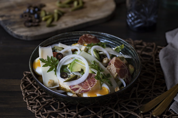 Caesar salade met gegrilde kip, avocado en rauwe ham van de Big Green Egg